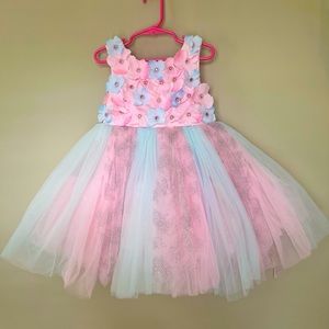 Cute layered floral ball gown with shimmer and artificial pearls on front.